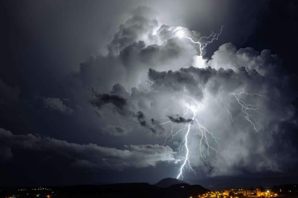 Big lightning strikes the ground at night